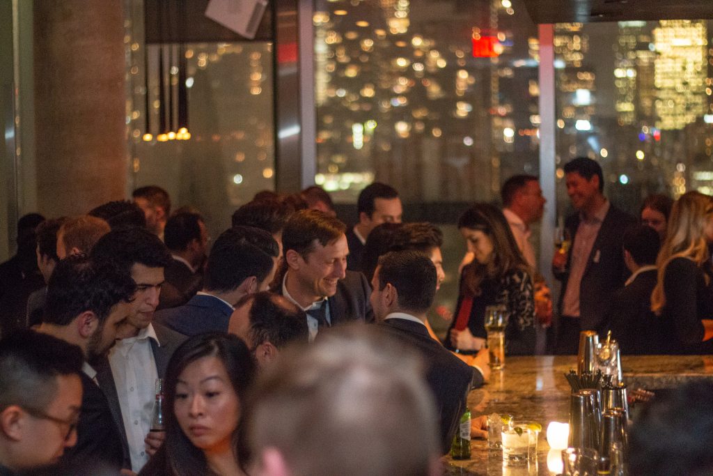 High angle of people networking near bar of social event