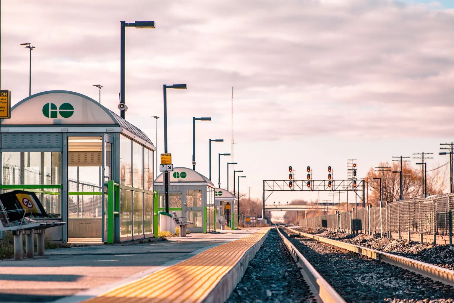 Inside train station, looking down the tracks with waiting areas to the left