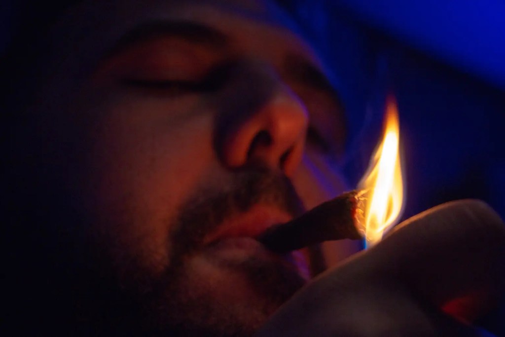 Close up of a man lighting his cigar