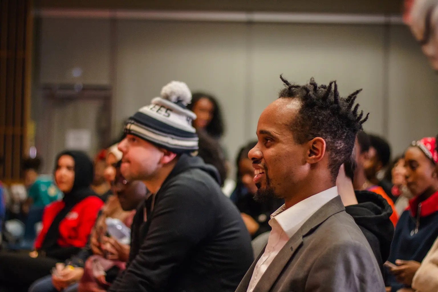 two male attendees sitting down and enjoying the show