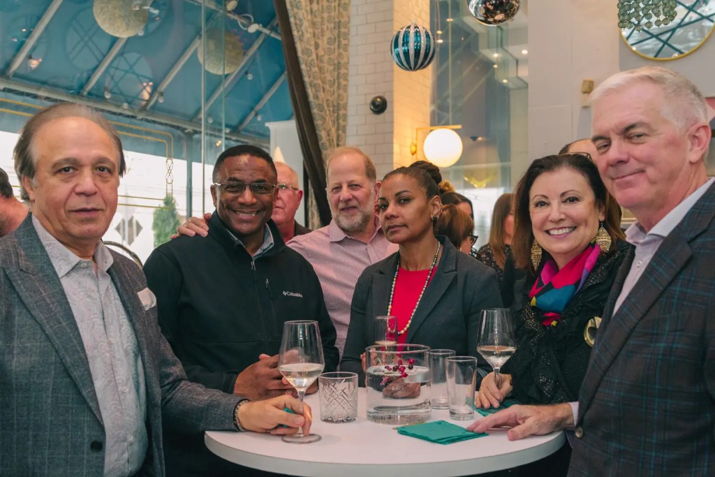 a group of people socializing over drinks at their table