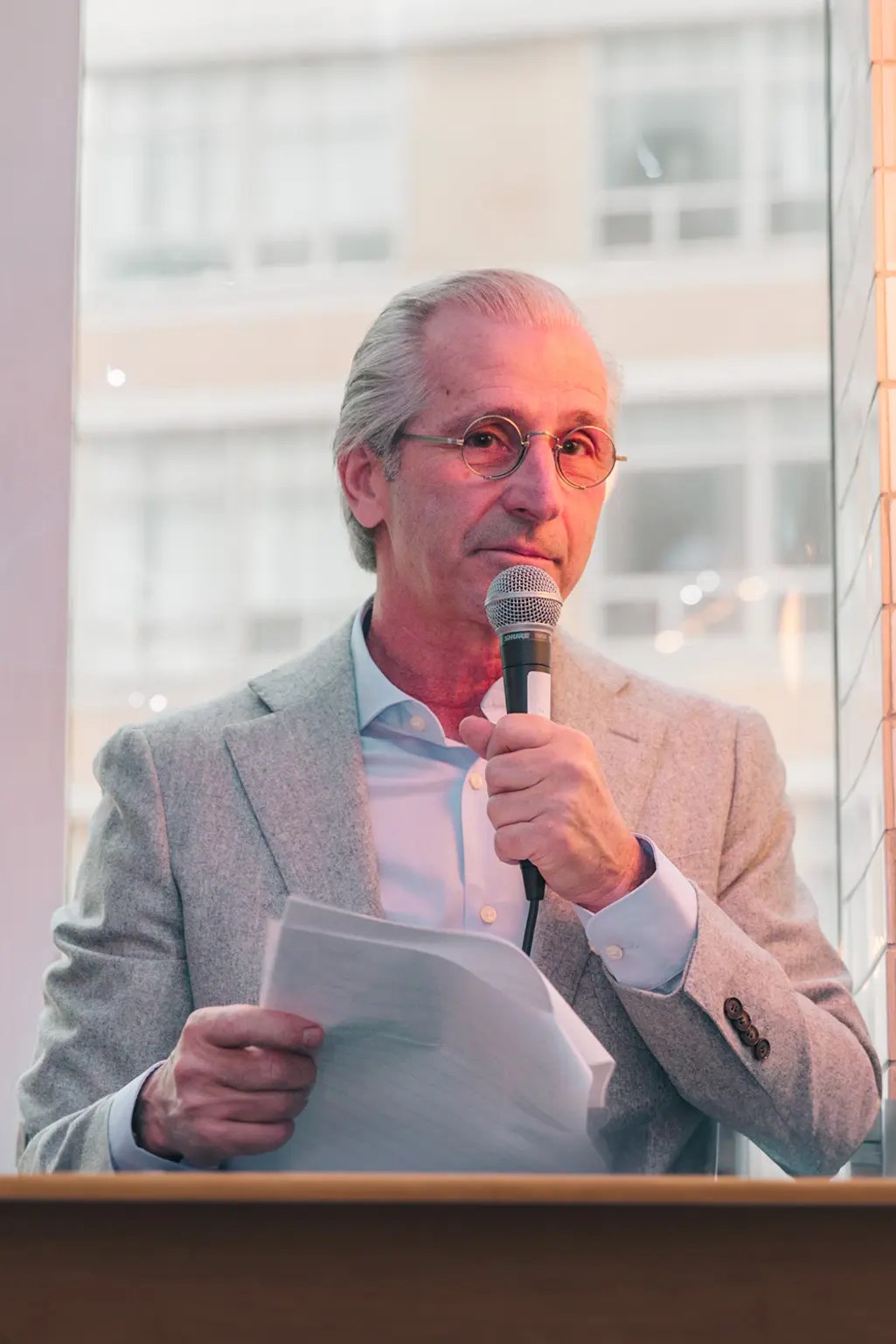 CEO holding a mic and speaking at the year end, holiday event