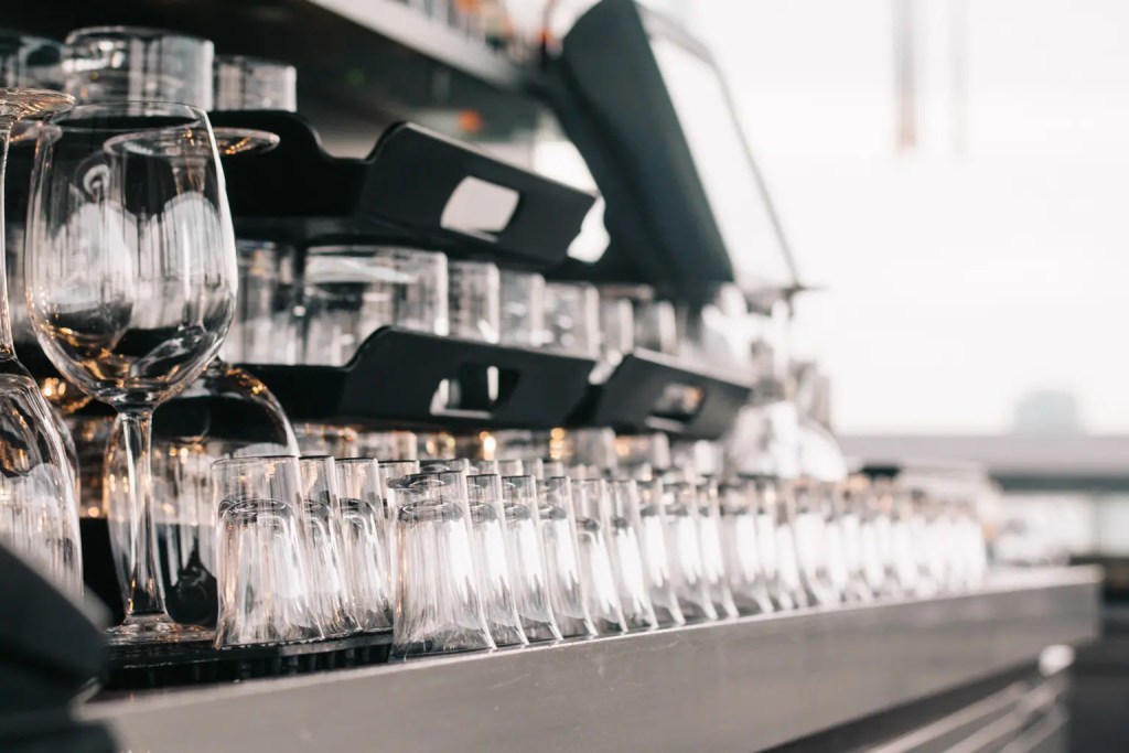 Clean shot, and wine glasses placed upside down behind the bar