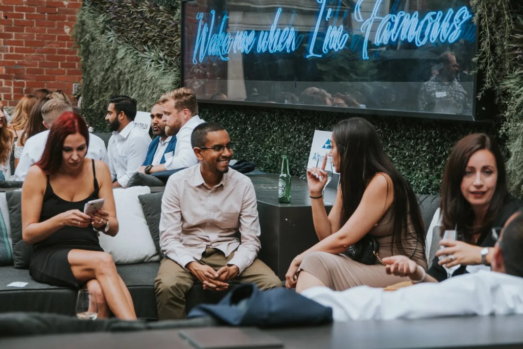 small group of people talking outdoors at a social event